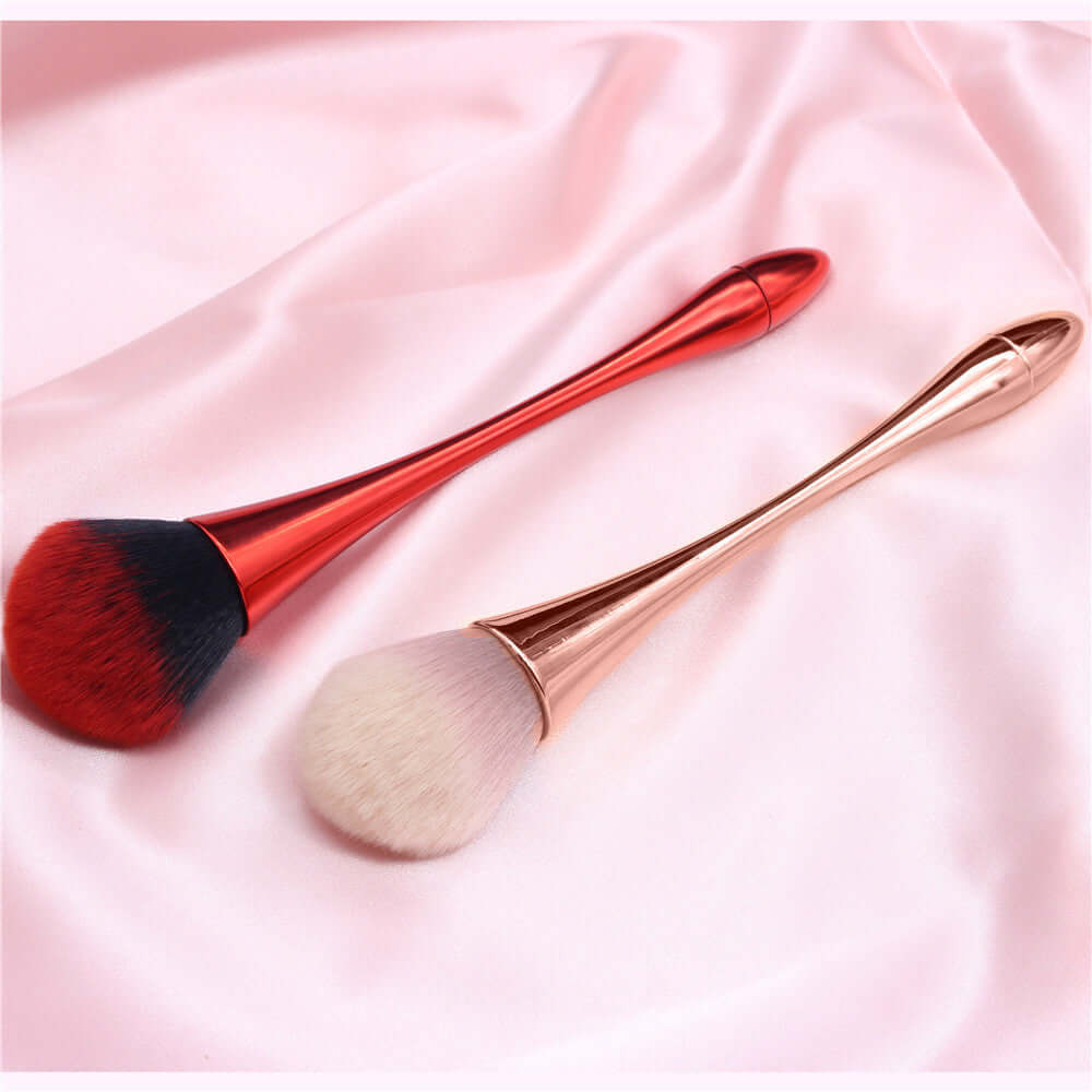 High-quality professional make-up tools, featuring red and rose gold cosmetic brushes on soft pink satin.