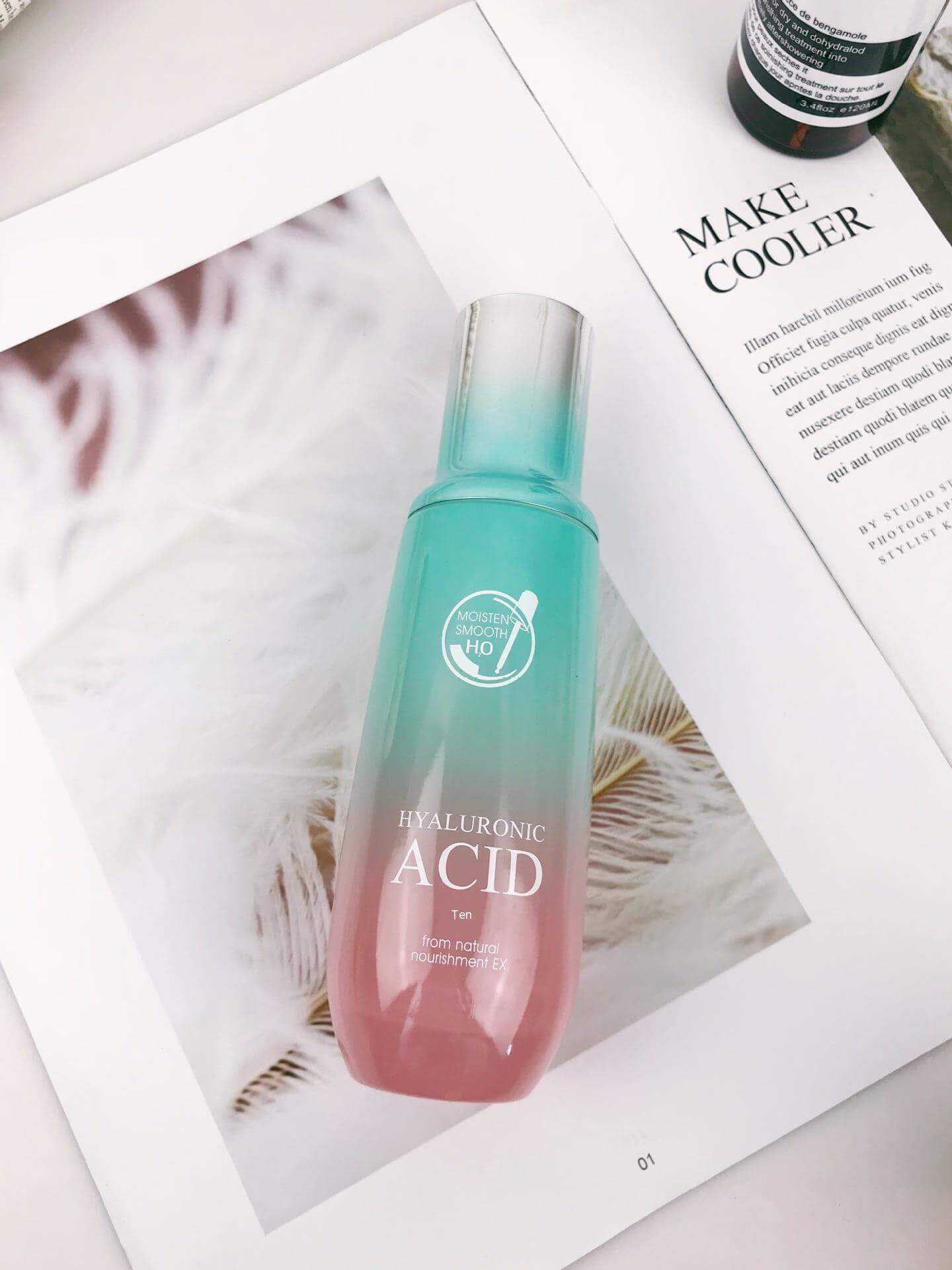 Hyaluronic Acid toner bottle on magazine page, promoting hydration in skin care routine for universal skin types.