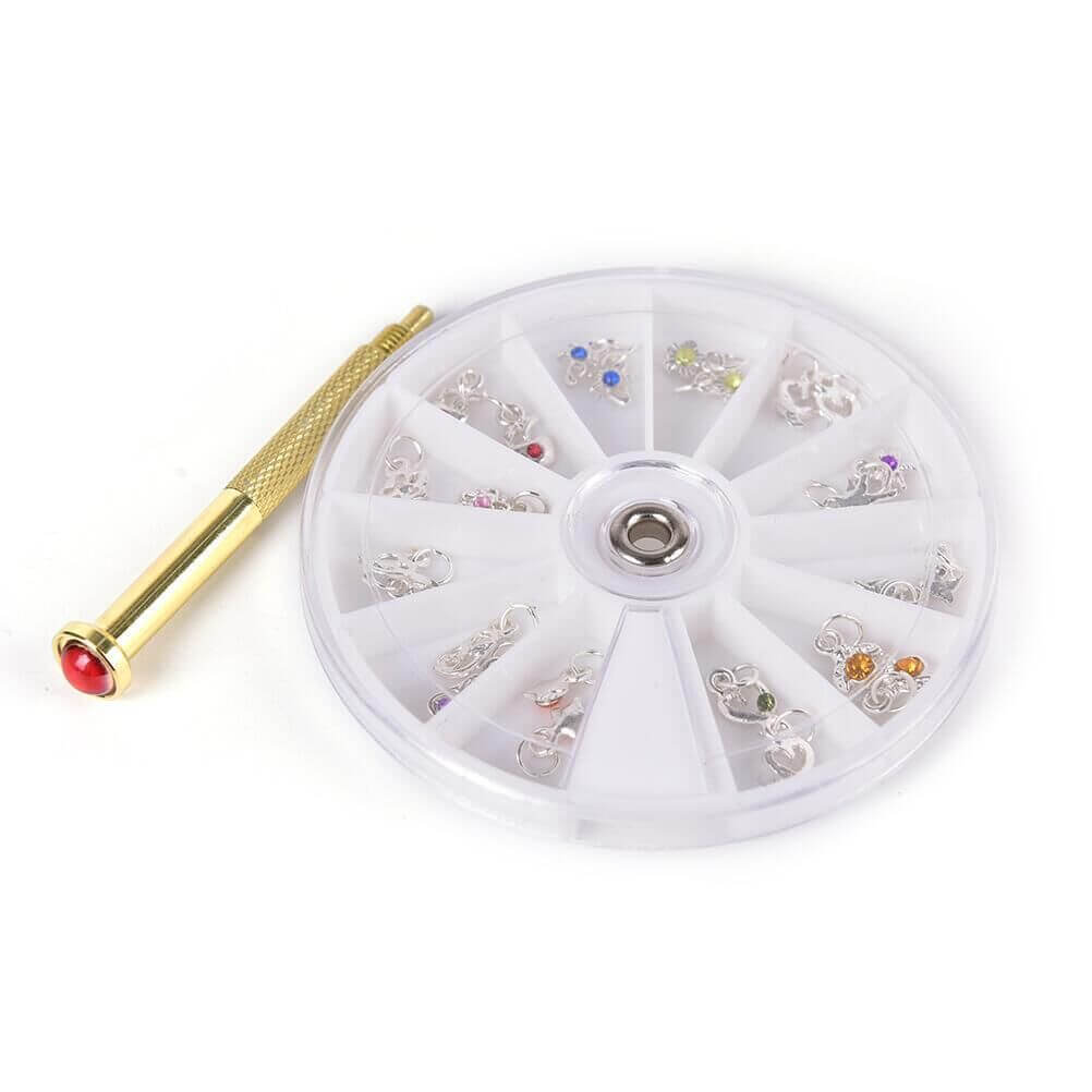 Nail accessories featuring a wheel of metal charms and a gold applicator tool for DIY nail art.