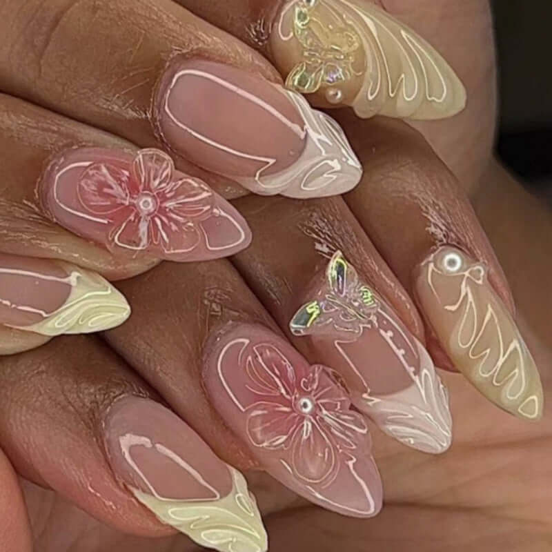 Handcrafted almond-shaped nails featuring floral designs and glossy finish, perfect for stylish ladies.