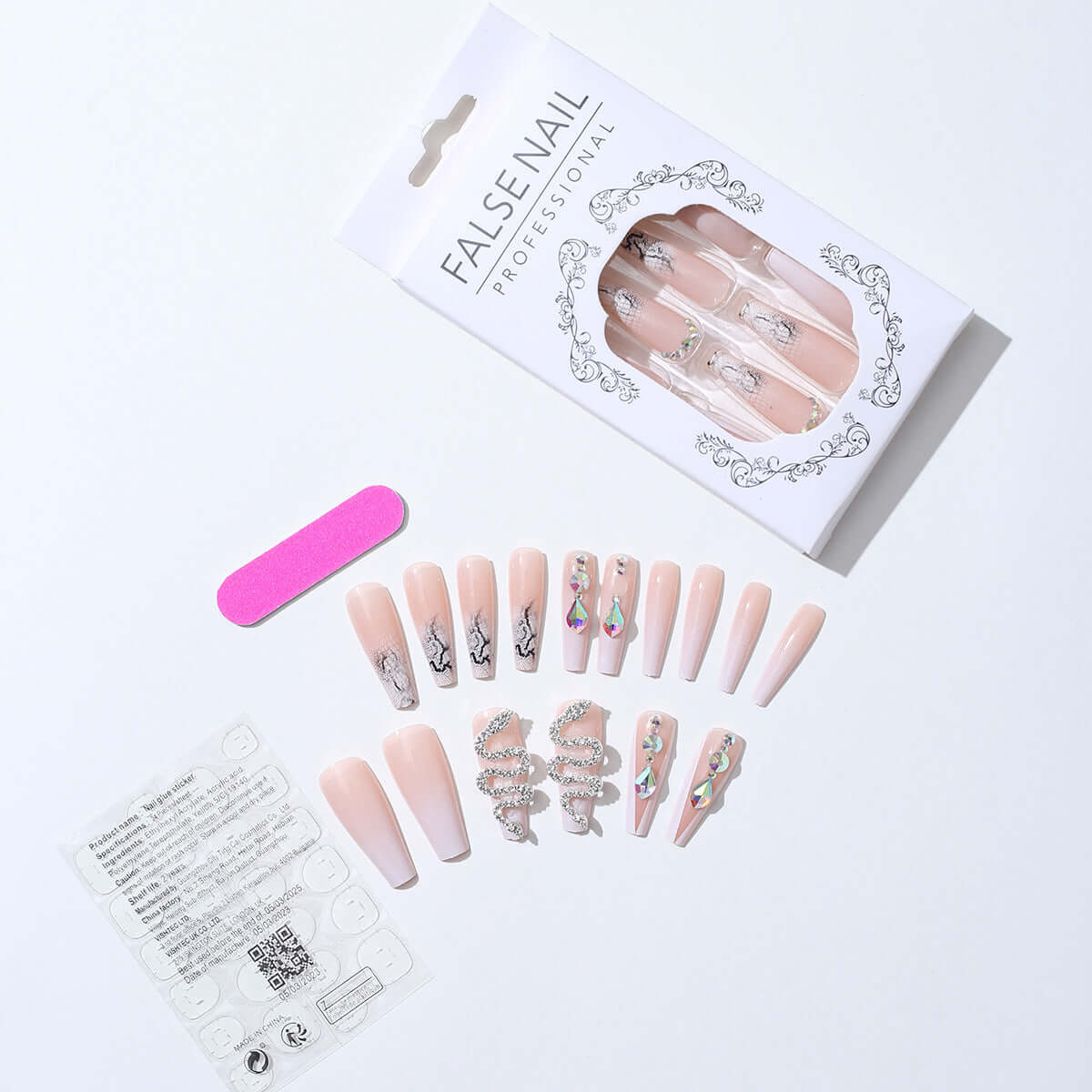 False nails set with cool silver snake and rhinestone designs, including a nail file in stylish packaging.