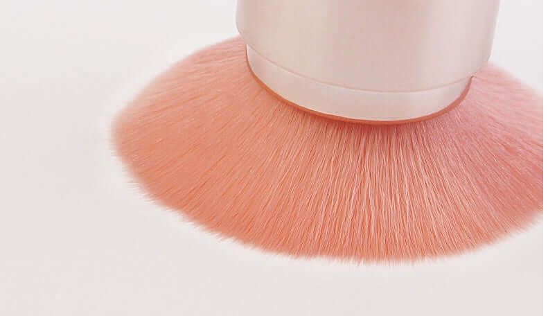 Close-up of a soft pink makeup brush bristles, showcasing high-density fibers for flawless application.