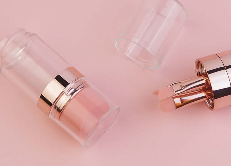 5-in-1 makeup brushes set with clear casing and rose gold accents on pink background.