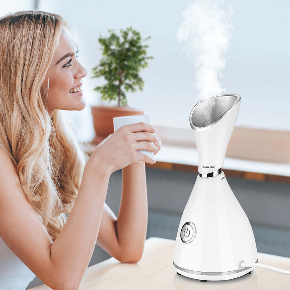 Beauty steamer facial moisturizer with hot spray and steam for skincare, woman using facial humidifier in white design.