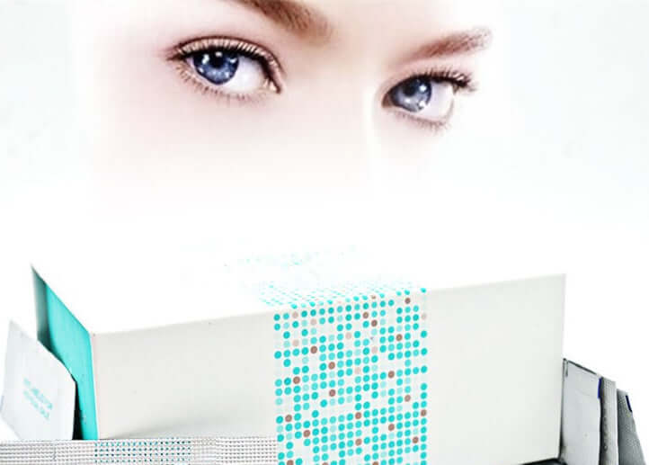 Close-up of a woman's blue eyes with Forever Young Eye Cream packaging in the foreground, highlighting moisturizing benefits.