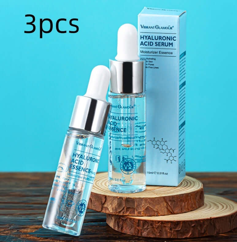 Hyaluronic Acid Serum bottles with packaging on wooden coaster for moisturizing essence in skincare.